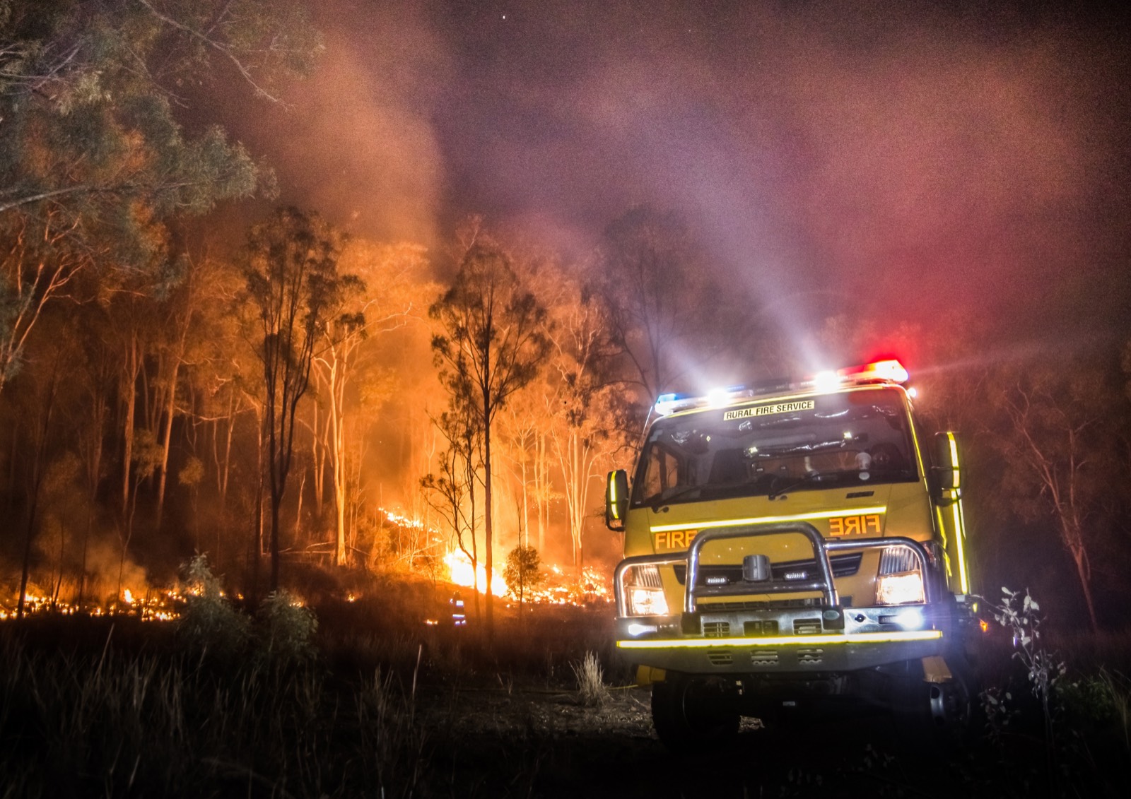 Volunteer rural fire brigade truck responding to a bushfire at night