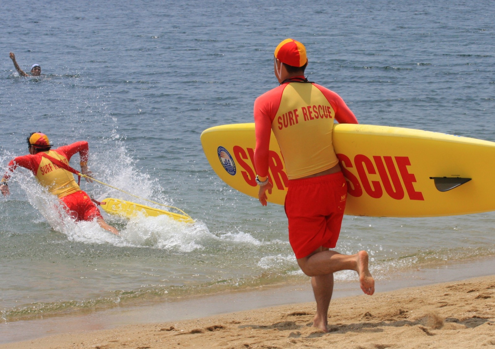 Volunteer surf lifesavers responding to a rescue