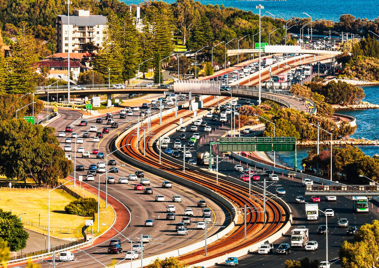 Perth freeway traffic running beside the rail line along the river
