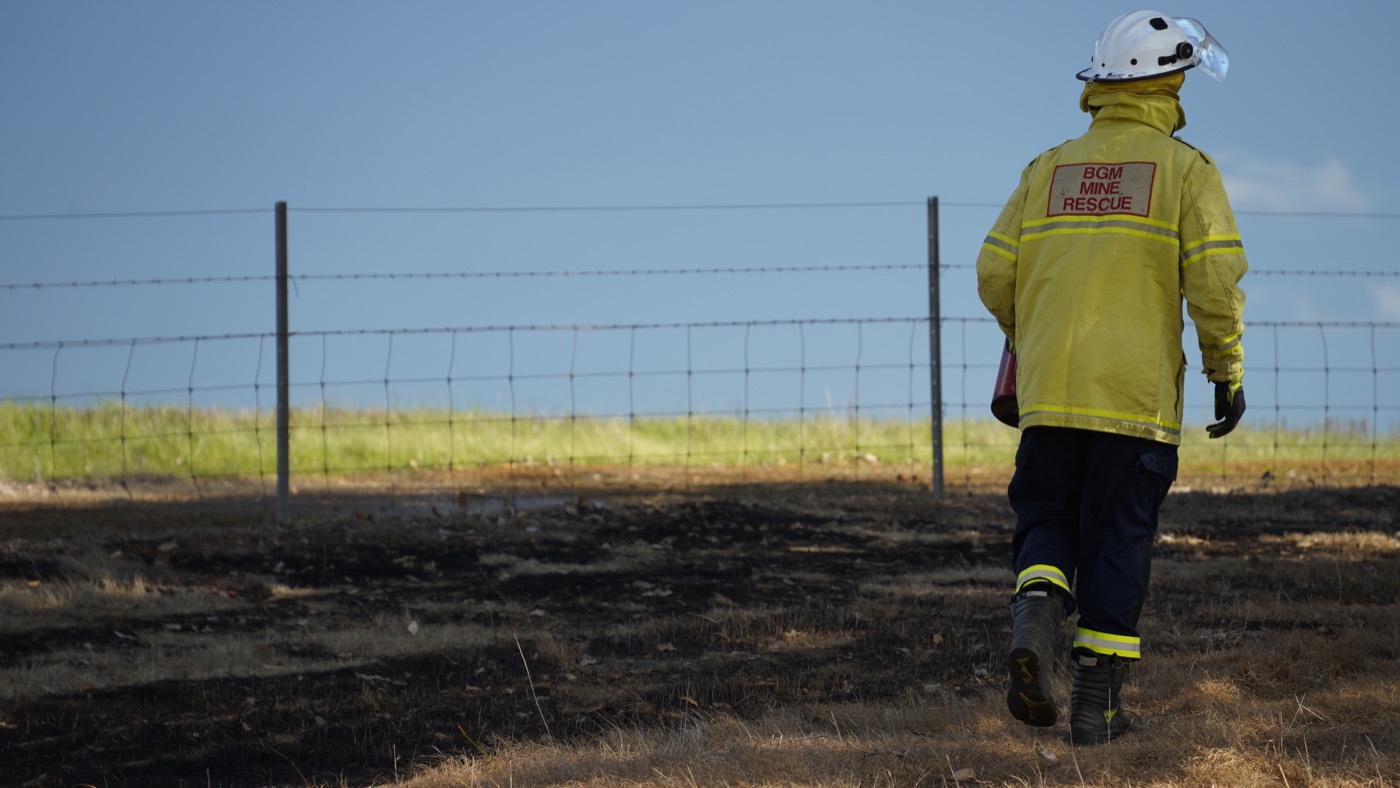 Mine rescue responder approaching a controlled bushfire training burn
